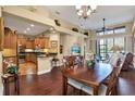 Open-concept living and dining area with wood floors, vaulted ceilings and lots of natural light at 4813 Michelle Ln, Palm Harbor, FL 34684