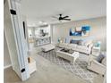 Bright living room featuring fresh paint, new flooring, and modern decor with an open floor plan at 7900 Hardwick Dr # 813, New Port Richey, FL 34653