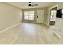 Spacious living room with neutral paint, plank flooring, and lots of natural light throughout the room at 7900 Hardwick Dr # 813, New Port Richey, FL 34653