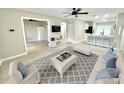 Bright living room featuring fresh paint, new flooring, and modern decor with an open floor plan at 7900 Hardwick Dr # 813, New Port Richey, FL 34653