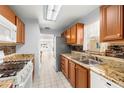 Bright kitchen with granite counters, stainless steel appliances, double sink, and a window for natural light at 10038 62Nd N Ter # 1, St Petersburg, FL 33708