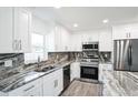 Modern kitchen with stainless steel appliances, elegant countertops, and ample storage space in white cabinetry at 114 25Th E St, Palmetto, FL 34221