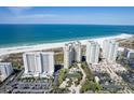 Stunning aerial view showcases the beachfront condo towers, pristine white sand, and sparkling ocean at 1200 Gulf Blvd # 902, Clearwater Beach, FL 33767