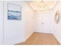 Bright entryway features wood floors, stylish light fixture, decorative mirror, and artwork at 1200 Gulf Blvd # 902, Clearwater Beach, FL 33767