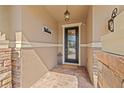 Inviting front porch with brick pavers, decorative stone accents, and elegant front door at 12225 Lake Blvd, New Port Richey, FL 34655