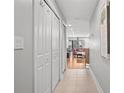Hallway view with tiled floor and white doors, leading into an open living area at 13140 Village Chase Cir # 13140, Tampa, FL 33618