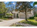 Charming two-story home featuring a well-manicured lawn, beautiful landscaping, and an attached two-car garage at 14841 Tudor Chase Dr, Tampa, FL 33626