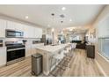 Bright, open kitchen with white cabinetry, stainless steel appliances, and an island with seating at 20778 Balsam Hill Rd, Land O Lakes, FL 34638