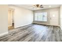 Bright living room featuring modern ceiling fan, wood floors, and a view to an adjacent room at 2253 Norwegian Dr # 67, Clearwater, FL 33763