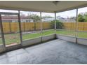 Enclosed screen porch featuring slate flooring and views of the backyard at 3094 Vernon Ter, Largo, FL 33770