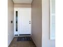 Entryway featuring a white front door with sidelight and tile flooring at 3212 Player Dr, New Port Richey, FL 34655