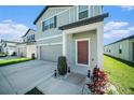 Charming exterior highlighting a well-manicured lawn, an attached garage, and a welcoming front door at 35542 Buttonweed, Zephyrhills, FL 33541