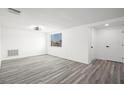 Bright bedroom with new gray vinyl floors and a window providing ample natural light at 3639 Richboro Dr, Holiday, FL 34691