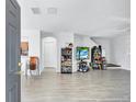 Open-concept living room featuring tile flooring, white walls, and plenty of natural light at 4106 Waterside Island Ct, Tampa, FL 33617