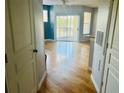 Bright living room featuring hardwood floors, sliding glass doors to balcony, and neutral paint at 5125 Palm Springs Blvd # 1203, Tampa, FL 33647