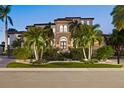 Beautiful Mediterranean-style home with professional landscaping and exterior illumination at 5128 W Longfellow Ave, Tampa, FL 33629