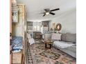 Cozy living room featuring a comfortable couch, ceiling fan, and decorative rug at 6202 Tennessee Ave, New Port Richey, FL 34653