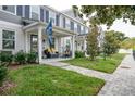 Inviting townhouse with a cozy porch and well-maintained landscaping at 6615 S Manhattan Ave # 2, Tampa, FL 33616