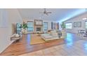 Bright and airy living room featuring a stone fireplace and hardwood floors at 6725 Islander Ln, Tampa, FL 33615