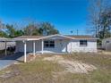 Charming single-story home featuring a carport, front yard, and freshly painted exterior at 7305 Windsor St, Hudson, FL 34667