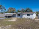 Charming single-story home featuring a carport, front yard, and freshly painted exterior at 7305 Windsor St, Hudson, FL 34667