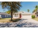 Charming single-Gathering home showcasing a two-car garage and manicured lawn at 8329 Moccasin Trail Dr, Riverview, FL 33578