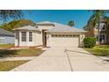 Charming single-Gathering home showcasing a two-car garage and manicured lawn at 8329 Moccasin Trail Dr, Riverview, FL 33578