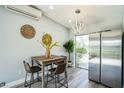 Cozy dining area featuring modern lighting, stainless steel appliances, and a view of the outdoors at 101 Sunlit Cove Ne Dr, St Petersburg, FL 33702