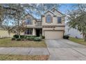 Charming two-story house with a two-car garage and manicured landscaping at 10909 Observatory Way, Tampa, FL 33647