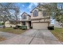 Inviting curb appeal with a well-kept lawn and an attached two-car garage at 10909 Observatory Way, Tampa, FL 33647