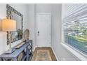 Bright foyer features a mirror, console table, and a window with natural light at 1109 Lady Gouldian Ct, Tampa, FL 33613