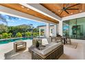Expansive outdoor patio featuring comfortable seating, a dining area, and a view of the pool at 1401 Brightwaters Ne Blvd, St Petersburg, FL 33704
