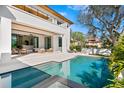 Inviting pool area with a spa, lounge chairs, and a covered patio for relaxing by the water at 1401 Brightwaters Ne Blvd, St Petersburg, FL 33704