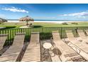 Beachfront lounge chairs offer a relaxing view of the ocean and sandy beach at 1460 Gulf Blvd # 506, Clearwater Beach, FL 33767