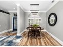 Charming dining room with wood floors, modern lighting, and a neutral color palette at 1708 Country Trails Dr, Safety Harbor, FL 34695
