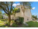 Exterior side view of a two-story home with lush landscaping and a well-manicured lawn at 280 Dr Ml King Jr N St, Safety Harbor, FL 34695