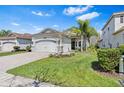 Charming single-story home with a well-manicured lawn, stone accents, and a two-car garage at 31046 Lindentree Dr, Wesley Chapel, FL 33543