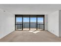 Bright living room featuring a wall of windows providing panoramic water views and natural light at 3301 Bayshore Blvd # 2007B, Tampa, FL 33629