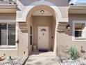 Inviting entryway with arched doorway and a stylish white front door at 3876 Timber Ridge Ct, Palm Harbor, FL 34685