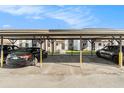 View of the covered carport and parking area showing assigned spaces at 39132 County Road 54 # 2060, Zephyrhills, FL 33542