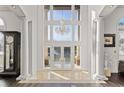 Grand foyer with soaring ceilings, a sparkling chandelier, and elegant marble flooring at 436 St Andrews Dr, Belleair, FL 33756