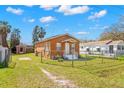 Spacious fenced backyard featuring a storage shed and ample green space at 6103 Anna Ave, Gibsonton, FL 33534