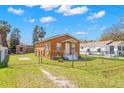 Fenced backyard featuring a storage shed and lawn at 6103 Anna Ave, Gibsonton, FL 33534