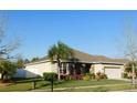 Inviting home boasting stone detailing, manicured landscaping, and an attached two-car garage at 6519 Sparkling Way, Wesley Chapel, FL 33545