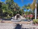 Beautiful pool area featuring a rock waterfall, lush landscaping, and relaxing spa at 681 Jasmine S Way, St Petersburg, FL 33705