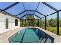 A private, screened in pool basks in natural light at 7235 Peacock Ln, Englewood, FL 34224