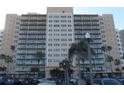 Towering exterior view of the condo building featuring multiple floors and balconies at 880 Mandalay Ave # C412, Clearwater Beach, FL 33767