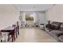 Inviting living area with updated floors, a cozy seating arrangement, and a sunlit window creating a warm atmosphere at 10265 Gandy N Blvd # 1203, St Petersburg, FL 33702