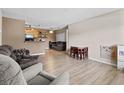 Spacious living room with plank floors, neutral paint, and open layout to kitchen and dining areas for modern living at 10265 Gandy N Blvd # 1203, St Petersburg, FL 33702