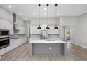 Modern kitchen features an island, stainless appliances, and an elegant backsplash at 13704 Oldenburg Dr, Hudson, FL 34667